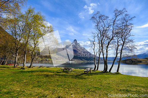 Image of Serene lakefront picnic spot with majestic mountain view in earl