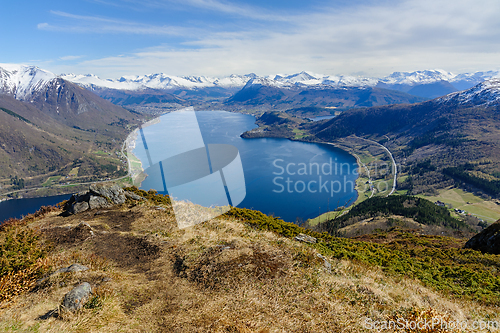 Image of Majestic highland vista: panoramic view over a serene fjord surr