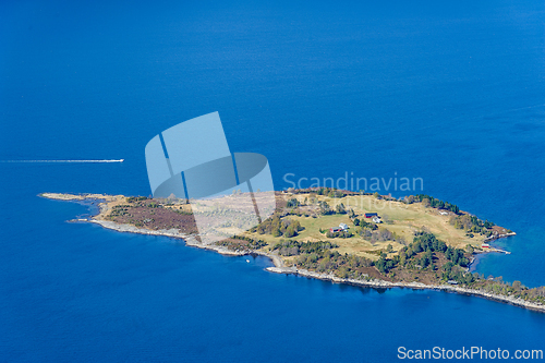 Image of Serene islet embraced by azure waters witnessed from above on a 