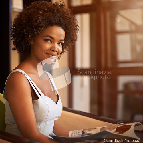 Image of Portrait, smile and black woman reading magazine at window in living room of home for weekend leisure. Book, morning and relax with confident young afro person in apartment for casual time off