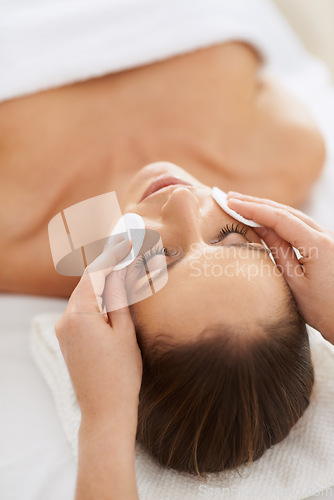 Image of Woman, pad and facial massage for cosmetics treatment to relax, cleaning and beauty therapy for skin care. Female person, calm and serene or dermatology, closeup and rest at hotel and peace or zen