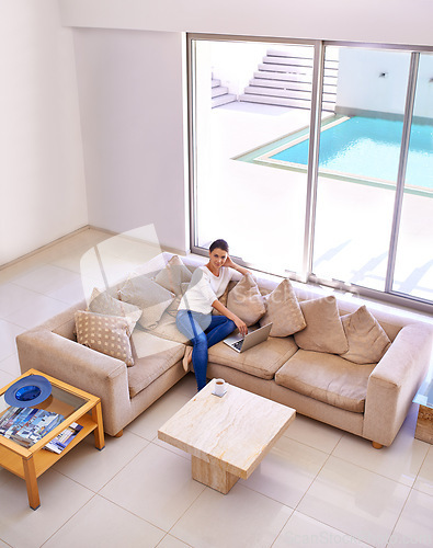 Image of Living room, relax and woman on sofa with laptop for remote work, internet or website subscription. Computer, online streaming and freelance girl in luxury home checking social media with high angle