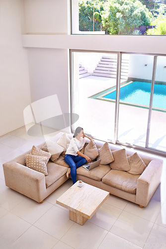 Image of Home, thinking and woman on couch with laptop for remote work, internet search and relax. Computer, online career or freelance girl on luxury sofa checking social media in living room with high angle