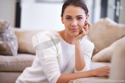 Image of Portrait, relax and woman with confidence in lounge on sofa for casual weekend in Canada. Comfort, pride and girl on floor in living room with peace, calm and carefree positive attitude for wellness.