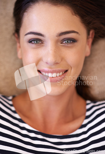 Image of Woman, portrait and smile on floor, above and pride with closeup, relax and home in living room. Girl, person and happy in headshot on carpet with fashion for morning in lounge in apartment in Italy