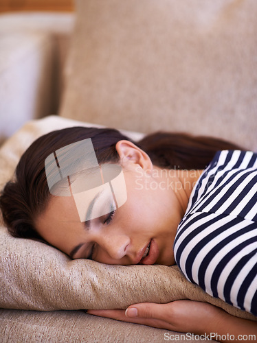 Image of Woman, sleep and peace to relax on couch, dream and lounge while lazy or comfortable in home. Female person, zen and rest on sofa in living room, eyes closed and calm for wellness and exhausted