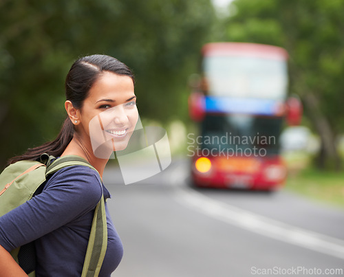 Image of Woman, backpack and portrait with waiting for bus with smile on travel, journey or vacation in summer. Girl, person and tourist with luggage, happy and outdoor on metro sidewalk for transportation
