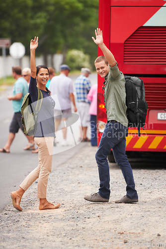 Image of Couple, happy and wave for bus, travel and backpack for adventure, journey or transportation on street. Man, woman and smile outdoor in portrait with vehicle for road trip for vacation in Costa Rica
