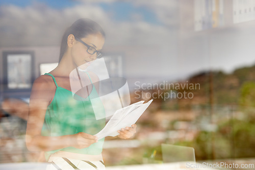 Image of Business woman, window and review documents for project, glasses for reading with editor and fact check article. Information, analysis and news with paperwork, proofreading and productivity in office