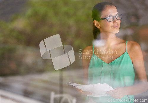 Image of Woman, thinking at window and documents for review, glasses for reading with editor and fact check article. Inspiration, knowledge and ideas with paperwork, proofreading and productivity in office