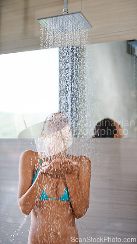 Image of Showering, wet and woman with wellness, bikini and healthy with morning routine and body. Person, hotel and girl with water and underwear with cleaning, grooming and happy with hospitality and liquid