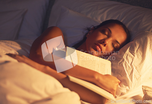 Image of Woman, sleep and book in bed and resting, dreaming female person or night lamp for story and novel. Relax, hobby and tired girl with fantasy or biography, literature or learning for peace in room