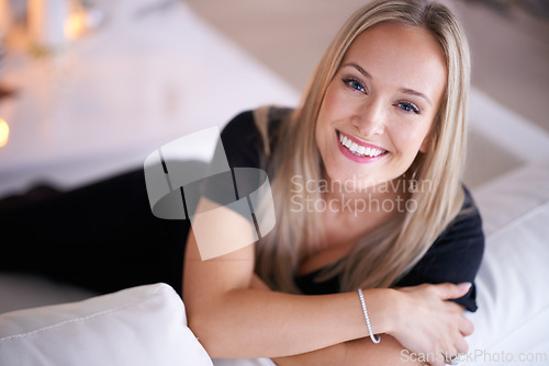 Image of Portrait, happy woman and relax on couch in living room, wellness and peace for break in home. Face, positive and blonde lady with rest on sofa, mindfulness and satisfaction on weekend in apartment