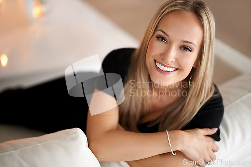 Image of Portrait, happy woman and relax on couch in home, wellness and peace with candles for zen. Face, positive and blonde lady with wax light on sofa, mindfulness and tranquility on weekend in living room