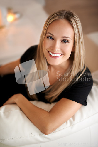 Image of Portrait, happy woman and peace on couch in living room, wellness and relax on break in home. Face, positive and blonde lady with rest on sofa, mindfulness and satisfaction on weekend in apartment