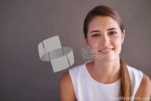 Image of Portrait, happy woman or smile in studio professional and confident person by grey background. French female, designer and pride on face for career growth and positive attitude in creative job