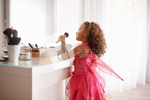 Image of Child, brush and mirror with makeup for skincare, beauty or happiness with cosmetics or smile. Girl, grooming and reflection of a young kid in with foundation, space or blusher in the home or house