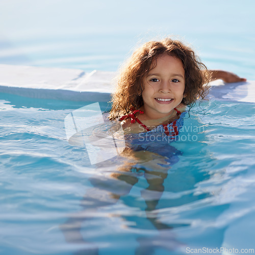 Image of Child, girl and swimming with face, swimwear and blue summer sky for relax or smile. Kid, youth and sunshine with happiness, outdoor and play with curly hair and fun for sunny positivity or childhood