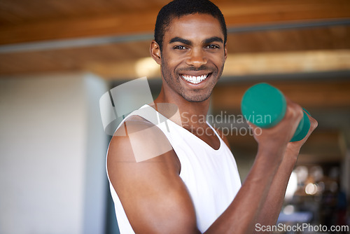 Image of Black man, smile and training with dumbbell for exercise, bodybuilding and performance goals. African person, portrait and equipment with lifting weights for wellness, strength and healthy body
