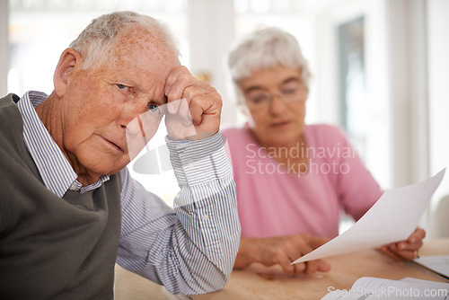 Image of Senior, couple and documents for discussion with worry, finance conversation for will at home. Elderly, stress or paper work reading with anxiety and retired people, pensioners with tax bill at table