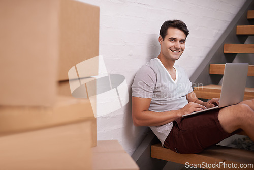 Image of Portrait, boxes and man with laptop in home for property investment, real estate or mortgage of new apartment. Homeowner, computer and face of happy male person for relocation, growth or renovation