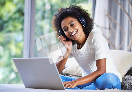 Image of Headphones, woman and laptop at home for online education, e learning and homeschooling in living room. Female person, scholar and university student in house for remote class, studying and tuition