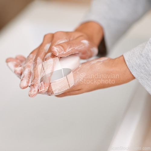 Image of Washing hands, soap foam and cleaning in bathroom for germs, bacteria or viruses as routine. Hygiene, healthcare and skincare person to prevent sickness or disease, habit and water for bubbles daily