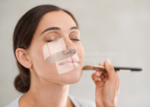 Image of Beautician, client and makeup with brush beauty and cosmetics for special event in studio. Female person, face products and blush or eyeshadow for confidence, skincare or stylish in white background