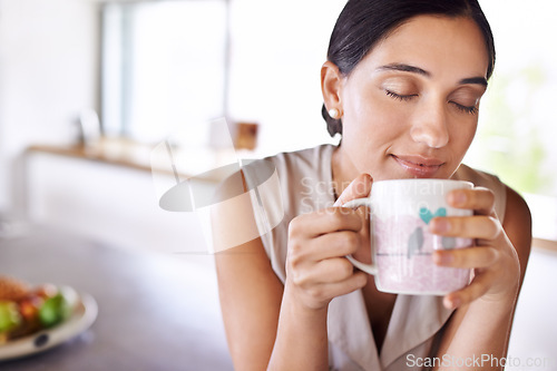 Image of Woman, relax and smell coffee on kitchen or morning, enjoying and holding mug or cup. Female person, drinking tea or expresso for breakfast or energy at home, eyes closed and smile indoors or house