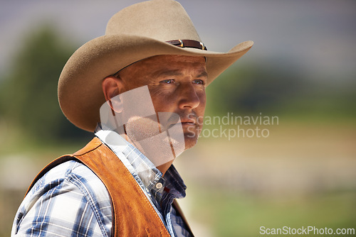 Image of Cowboy, ranch and thinking in outdoor, sun and serious for wrangler and Texas farmer at stable. Mature man, wild west and summer in agriculture, hat and person with shirt in farm job and environment