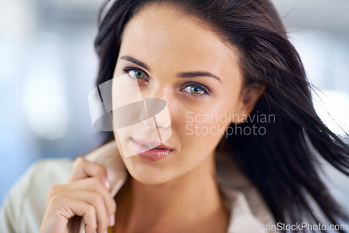 Image of Portrait, confidence or business woman in office for career, job and serious agent working in workplace. Face, professional entrepreneur and employee or young female person with wind in hair in Spain