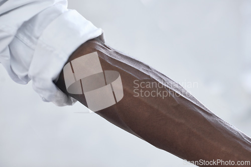 Image of Strong, person and vein from muscle in arm with shirt, fashion and closeup in white background. African, skincare and forearm of model with healthy fitness, wellness or muscular bodybuilder in office