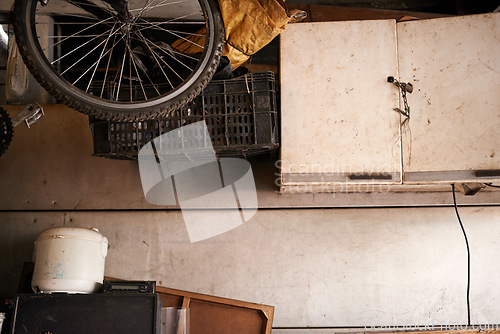 Image of Storage, bicycle and tools in shed house with old wood interior and rust with trash. Home, garage and bike in slum with broken furniture or equipment in crates to store instruments in boxes.