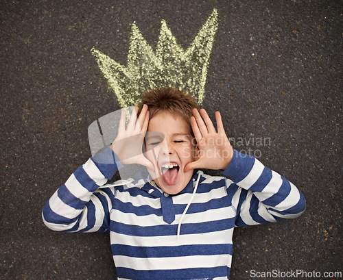 Image of Chalk art, funny face or boy with crown on floor for drawing, imagine or future fantasy on black background. King, emoji or kid with royalty, sketch prince or dream for school, project or assignment