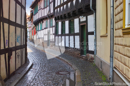 Image of Narrow, alley and building in road, Germany and historic cobble stone street or architecture in village for tourists. Structure or traditional design, creative home in old town real estate or path