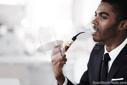 Image of Businessman, smoking and vaping in office electronic cigarette and tobacco in formal clothes or outfit. Black man, corporate and thinking or ideas in workplace and salesman in company or career