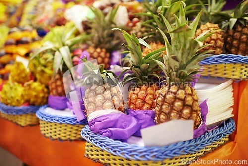 Image of Pineapple, fruit and fresh produce at farmer market, vitamins and healthy food for groceries. Retail, sales and merchandise of sweet tropical products, fiber and vitamin c from local producer