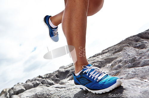 Image of Closeup, running shoe and rocky terrain or nature, fitness and exercise for health. Footwear, trail and cardio jogging for marathon training, fun and wellness on off road and cross country routes