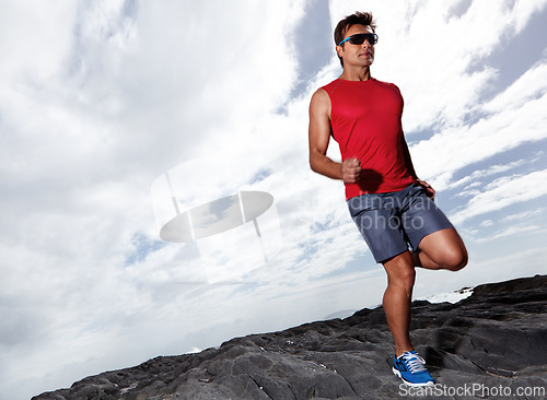 Image of Athlete male person, running and outdoor for fitness, health and wellness in activewear and sunglasses. Man, jog and seaside for sport, train and gym in workout and exercise for cardio routine