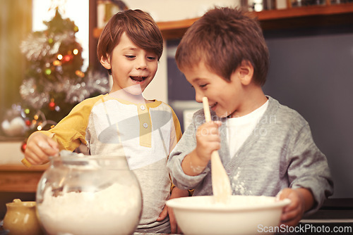 Image of Boys, baking and happy in kitchen with flour, home and learning with ingredients for christmas cake. Children, mixing or bowl for cookies on counter, biscuits or pastry recipe for holiday celebration