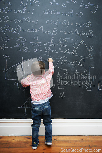 Image of Child, math and blackboard with writing in classroom for knowledge, development and young genius in school. Kid, numbers and formula on chalkboard with learning for education, growth and solution