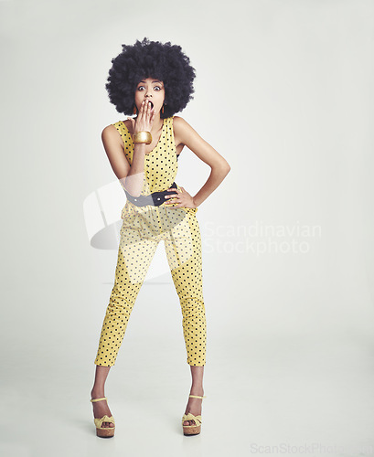 Image of Black woman, surprise and afro with style in fashion, deal or special offer on a gray studio background. Portrait of young African, female person or retro model in shock or outfit on mockup space