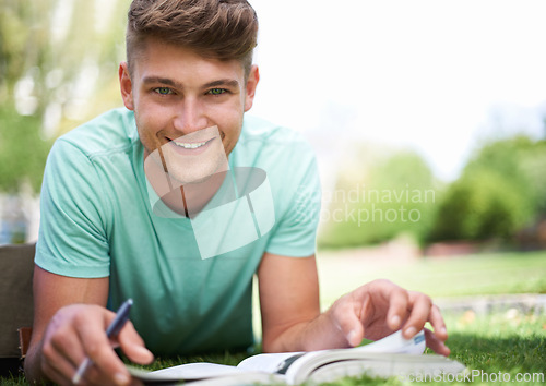 Image of Man, studying and books on grass for portrait, smile and pride for learning, development and reading. Person, university student and happy with notes, information and knowledge for college education