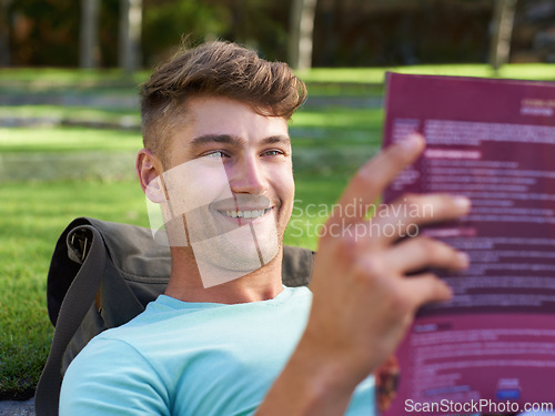 Image of Man, student and book on lawn for reading, smile and ideas with learning for development at campus. Person, studying and happy with scholarship, information and knowledge for education at college