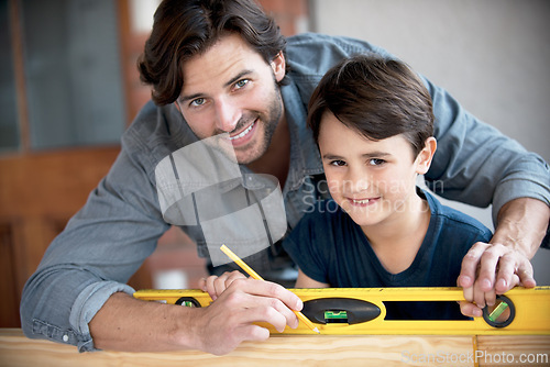 Image of Father, kid and woodwork at home for portrait, bonding and building with safety gear. Dad, son and carpenter for renovating, measuring and teaching moment for development of house with construction