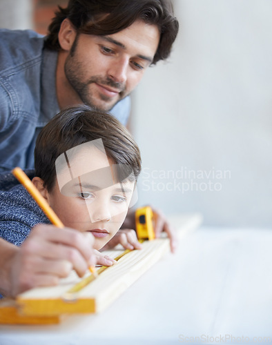 Image of Father, son and woodwork or teaching construction with measuring tape or development, bonding or home repairs. Male person, child and parenting for carpenter learning or furniture, lesson or building
