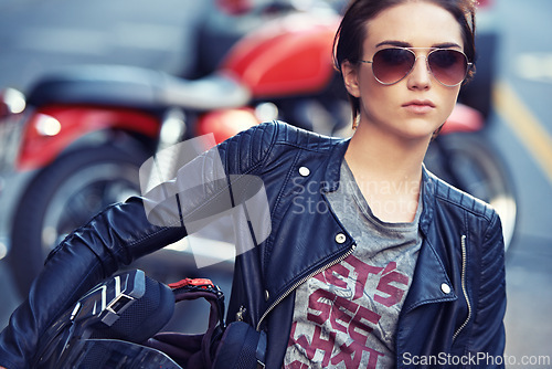 Image of Motorcycle, sunglasses and woman biker in city with leather jacket for travel, transport or road trip. Fashion, rebel and female person with grunge, gothic or edgy punk style for bike in town.