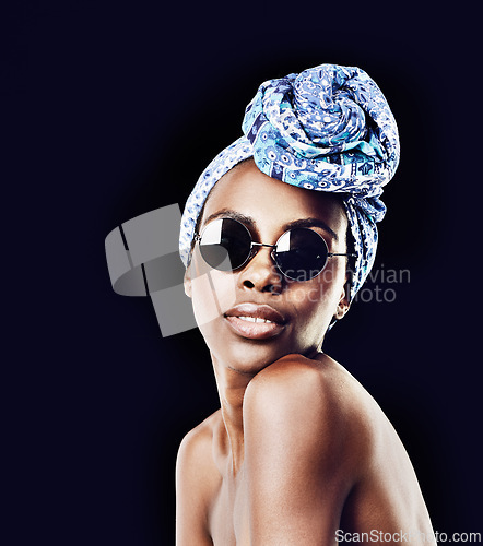 Image of Portrait, beauty and fashion with African woman in studio isolated on black background for heritage. Culture, model and sunglasses with confident young person in trendy headwear for traditional style