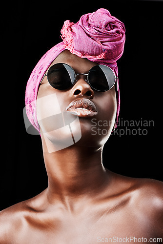 Image of Face, fashion and culture with African woman in studio isolated on black background for heritage. Aesthetic, model and sunglasses with confident young person in trendy headwear for traditional style