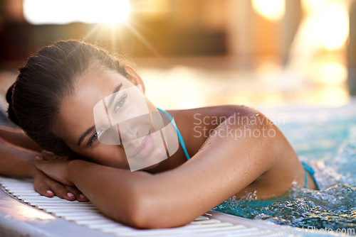 Image of Happy woman, relax and lying with water in jacuzzi for holiday, getaway or stress relief at hotel, resort or spa. Face of calm and young female person with smile in hot tub or warm pool on vacation